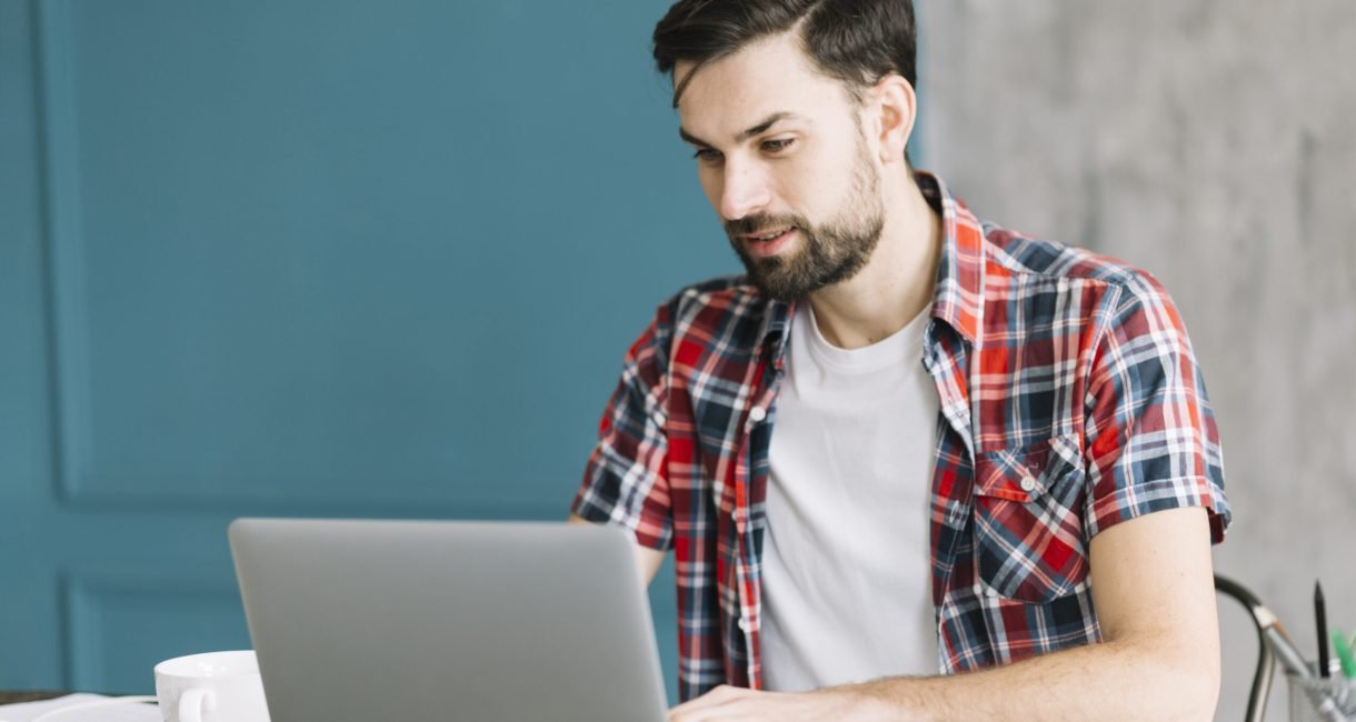 man-with-laptop-sitting-table